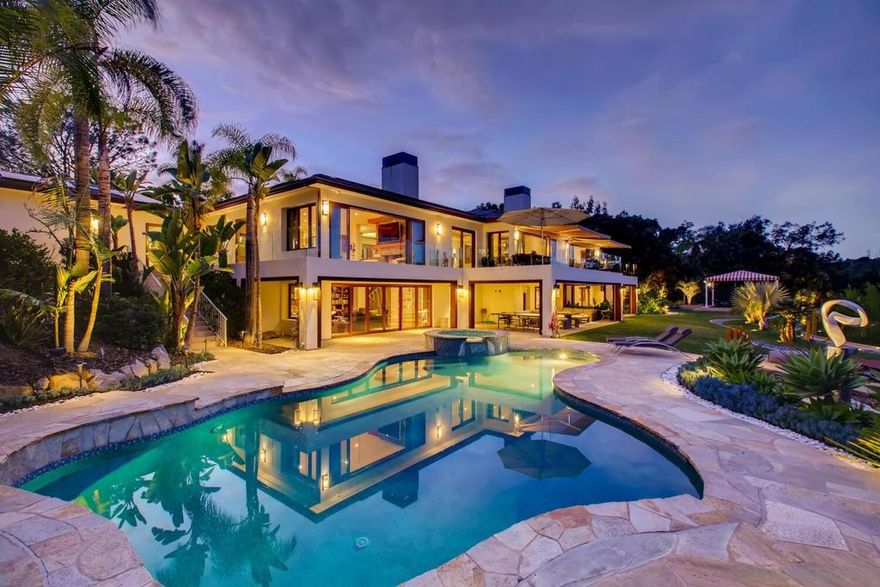 In a spectacular 1.7 acre walled showcase of contemplative design with lavish application of lush landscaping, magnificent natural stone and exotic woods for a perfect melding of elements into this tranquil protected natural canyon environment, this estate with a separate-address, 1,700 sq ft, 2 BR,2 ba guest house offers not only sublime gated privacy and luxurious scale and resort amenities with wide open canyon views, but represents an extraordinary value. Exceptionally well-built and recently updated in exquisite taste, this home's vast indoor and outdoor living areas include a fabulous theater, large recreation room, pool, spa, fire pit, and outdoor seating areas, all with endless opportunities for fun and entertainment on an intimate or grand scale.  Living areas are appointed with exquisite cherry cabinetry, Panto windows for adjustable privacy and ventilation with German hardware, finest oil rubbed Ipe flooring, Vantage lighting system, and marble and onyx stone appointments throughout, (including Elk Mountain Stone, Sunset Gold Quartzite, copper slate kitchen backsplash and a slate roof,) and include the main level master with terrace, maids' quarters, two spacious family rooms, a theater with acoustically treated soundproofing, a professional fitness gym with soak tubs and kitchenette, as well as gracefully terraced patios to a sensational pool and spa area with raised firepit conversation pad. No expense was spared in creating one of La Jolla's most exquisite homes with 100 solar panels.