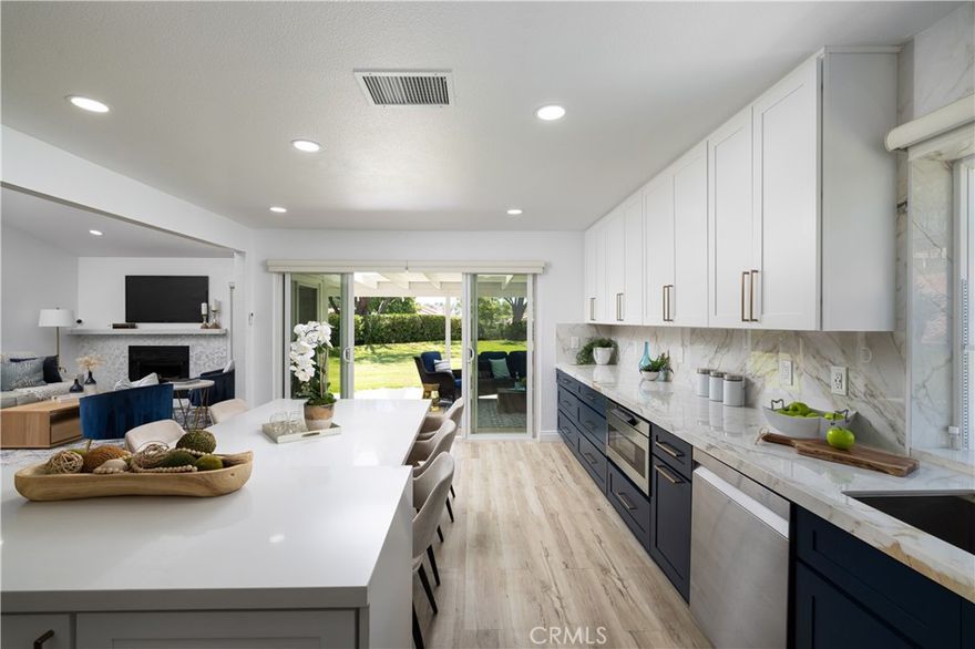 Experience the epitome of 55+ gated living in this stunning, completely remodeled ranch-style home, ideally located on a quiet cul-de-sac in Mission Viejo’s desirable Casta Del Sol community. This nearly 1,500 sq. ft. residence offers three bedrooms and two bathrooms, with a unique private setting and no direct neighbors to both sides or behind. The home has been meticulously upgraded throughout. The designer gourmet kitchen is a showstopper, featuring a quartz island, Italian porcelain countertops, new cabinetry, a pot filler, drawer microwave, matching stainless steel appliances, and a walk-in pantry. Bi-fold glass doors frame lush greenbelt views and create seamless indoor–outdoor living, opening to a spacious entertainer’s backyard with a covered patio and skylights. The primary suite impresses with vaulted ceilings, recessed lighting, and a thoughtfully designed walk-in closet. The spa-style bath boasts dual sinks, Quartz counters, and a large walk-in shower with dual shower heads. Two secondary bedrooms and a fully remodeled bath with marble countertop complete the home. Additional highlights include new flooring, paint, double-pane windows, electronic blinds, a new hot water heater, nearly new HVAC, and a complete repipe. An attached two-car garage offers pull-down attic storage. The property also benefits from low taxes, no Mello Roos, and full membership to Lake Mission Viejo for fishing, boating, concerts, and more. Residents enjoy the many amenities of Casta Del Sol, including two recreation centers with pools, spas, tennis and pickleball courts, gym, hiking trails, shuffleboard, billiards, and more. This move-in ready home is a rare find—better hurry on this one!