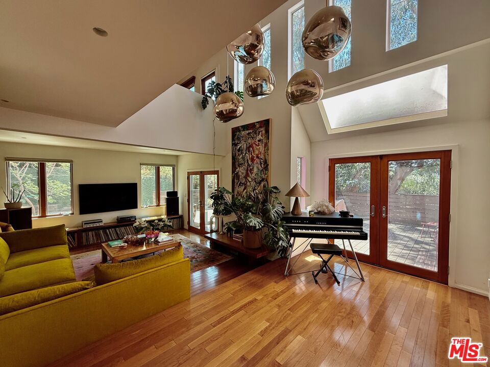 Step into the personal residence of a celebrity designer, now available for lease FULLY FURNISHED and ready to impress. Tucked away in the hills of Echo Park (Elysian Heights), this one-of-a-kind home is a true entertainer's paradise and zen retreat, offering captivating city views, curated interiors, and a seamless indoor-outdoor flow. The main house features 3 bedrooms and 2 bathrooms, with the entire upper level dedicated to a luxurious primary suite complete with spa-like bath, generous closets, and a private patio overlooking the city skyline. The heart of the home is a warm and sophisticated open-concept living area where the custom wood-clad kitchen, dining room, and lounge open directly onto a sprawling outdoor deck, perfect for hosting under the stars. A gazebo-style cabana completes the setting, adding a touch of resort-like ambiance. Two additional bedrooms are thoughtfully placed on the main level, offering comfort and style. Below the main residence is an independently accessed studio space, ideal for a home office, creative studio, gym, or guest quarters. With designer furnishings, layered textures, and a special ambiance that can't be replicated, this home delivers an elevated living experience in one of LA's most quintessential hillside enclaves. Minimum 13 month lease term required.