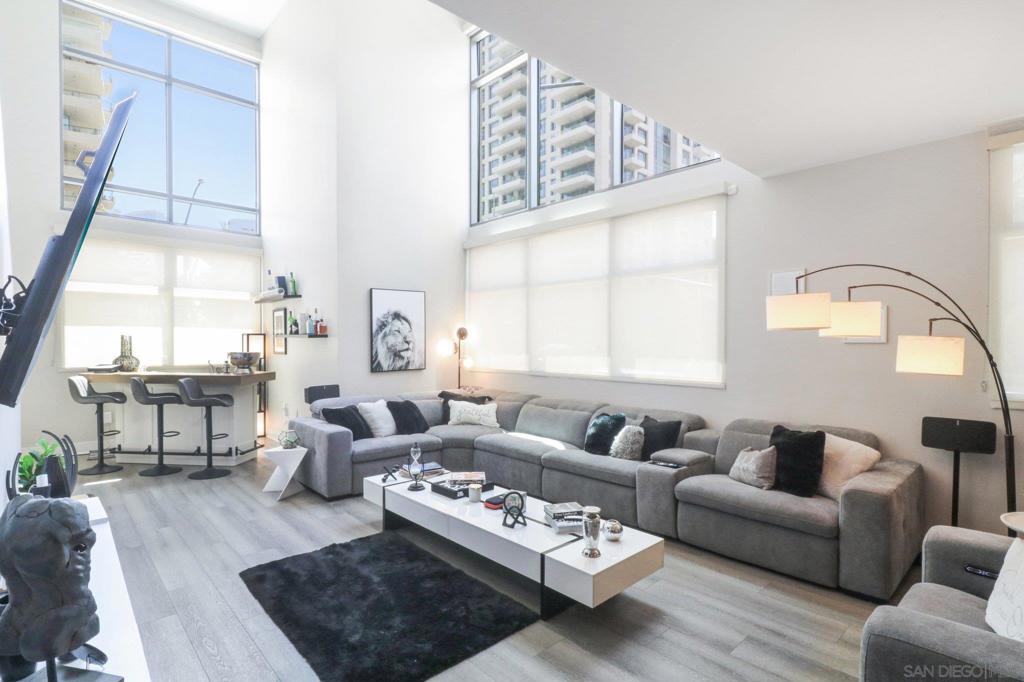 Rare 3-Bedroom Townhome in the Heart of the Marina District. Experience the feel of a downtown home with the convenience of luxury condo living at Renaissance in the Marina District. This spacious 3 bed, 3 bath residence spans nearly 2,000 sq ft and offers a rare street-level entry, perfect for guests or live/work flexibility. Inside, enjoy dramatic ceilings, floor-to-ceiling windows, and an open-concept kitchen featuring a Sub-Zero refrigerator, stainless steel appliances, and a large island ideal for entertaining. The thoughtful layout includes one bedroom and full bath on the main level, plus two ensuite bedrooms upstairs, including a generously sized primary suite and in-unit laundry. Recent updates include custom anti-sound curtains for added privacy and comfort. Located just steps to grocery stores, fine dining, Petco Park, and the waterfront.