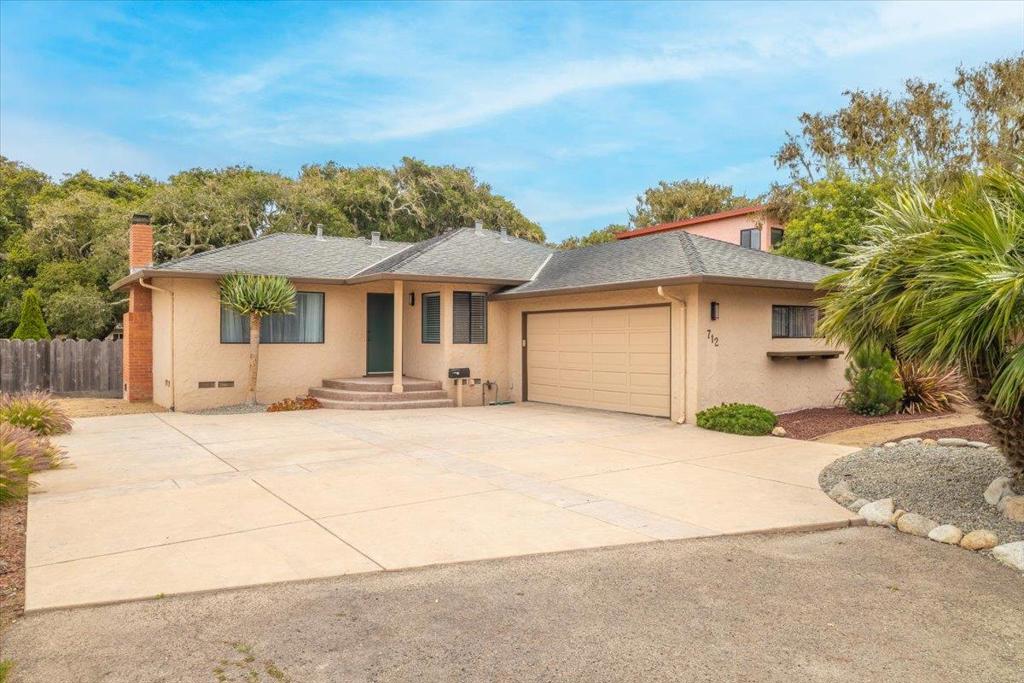 Nestled in the charming city of Pacific Grove, this delightful home offers 1,316 sq ft of comfortable living space on a large 10,400 sq ft lot. Three bedrooms and two full bathrooms, featuring stall showers and a separate tub, cater to a modern lifestyle. The kitchen comes equipped with a gas oven, refrigerator, a built-in microwave, and dishwasher, perfect for culinary enthusiasts. The living area boasts beautiful flooring and a fireplace, creating a warm ambiance for relaxation. Laundry facilities are conveniently located in the garage, which also offers ample space for two vehicles. The backyard is majestic, featuring live oak trees and ample space for entertaining and outdoor enjoyment. This backyard is an ideal location for building an ADU. The property offers close proximity to local schools, shopping and the beach. Come enjoy Butterfly Town USA.