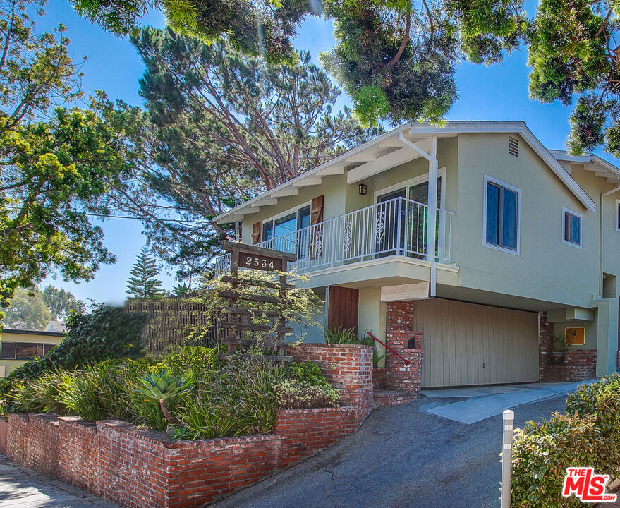 Discover an enchanting and unique 2-bedroom, 1.75-bathroom unit, featuring a lovely balcony with treetop views and refreshing ocean breezes, nestled on a hill in Ocean Park, west of Lincoln. The light-filled and private upstairs unit boasts a high vaulted ceiling, hardwood floors throughout, stained glass window and a cozy wood-burning fireplace. The spacious kitchen has everything you need including a dishwasher for easy clean-up! Enjoy the convenience of on-site laundry and an attached private two-car garage. Situated in a wonderful residential neighborhood, it's just a short distance to Main Street's shops, restaurants, and the beach!