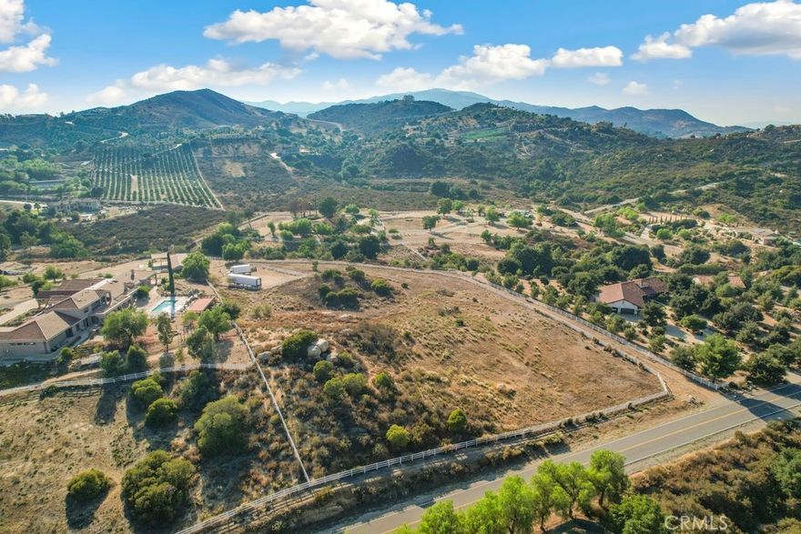 Stunning 5.38-Acre Parcel in Prestigious La Cresta Community. Surrounded by multi-million-dollar estates and nestled within the sought-after equestrian neighborhood, this land offers privacy, prestige, and potential. Discover the perfect canvas for your dream estate in the exclusive La Cresta community. This exceptional parcel is ideally situated off Via Baya and Via Majorca, just 8 miles from the I-15 freeway and close to premier shopping, fine dining, and amenities. Set in a peaceful location, the property offers breathtaking views of the surrounding mountains and city lights. Enjoy the serenity of country living with the convenience of city access nearby. Fully fenced and equipped with a water meter, this lot is ready for development. Whether you're envisioning a custom luxury home, a private equestrian retreat, or a peaceful weekend escape, the possibilities are endless. Located just a short drive from the world-renowned Temecula Wine Country, this is a rare opportunity to invest in one of Southern California’s hidden gems.