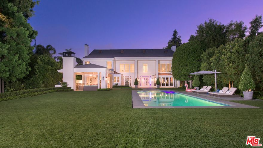 Incredible custom built Traditional home, with no expenses spared located on one of the best flat, usable lots that Brentwood has to offer. With a long driveway, this home is completely private from the street. This beautiful custom home includes four bedrooms upstairs, office, media room, and stunning canyon views. The backyard is an absolute dream with its park-like size, large pool, lush lawns, fire pit area, and a two-story guest house with a full kitchen, spacious gym, two bedrooms, and two bathrooms. Located on the rim side of North Carmelina. Properties like this very rarely ever become available. This is a truly spectacular home for the most discriminating Buyer.