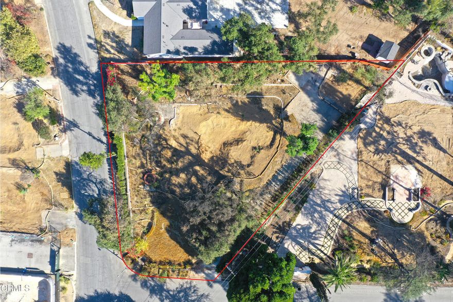 Discover a premier 24,266 sq. ft. lot nestled in the coveted Altadena foothills. Enjoy unmatched privacy and sweeping views of the San Gabriel Mountains, tranquil skies, and breathtaking sunsets. Surrounded by mature trees and natural beauty, this setting offers both peace and inspiration--ideal for creating a luxurious architectural masterpiece, lush garden retreat, or entertainer's paradise. Whether your vision is a sleek modern showpiece, a timeless Spanish Revival, or a warm ranch-style haven, this exceptional property offers limitless potential in a prime location that feels a world apart yet remains close to everything. Phase 2 debris removal has been completed by the U.S. Army Corps of Engineers. A previous 4-bedroom, 4-bathroom English Tudor Revival home once stood on the lot, totaling approximately 3,444 square feet with a large basement. Opportunities where privacy, natural beauty, and visionary possibility align are exceedingly rare. The property is being sold as-is. Don't miss your chance to create something extraordinary.