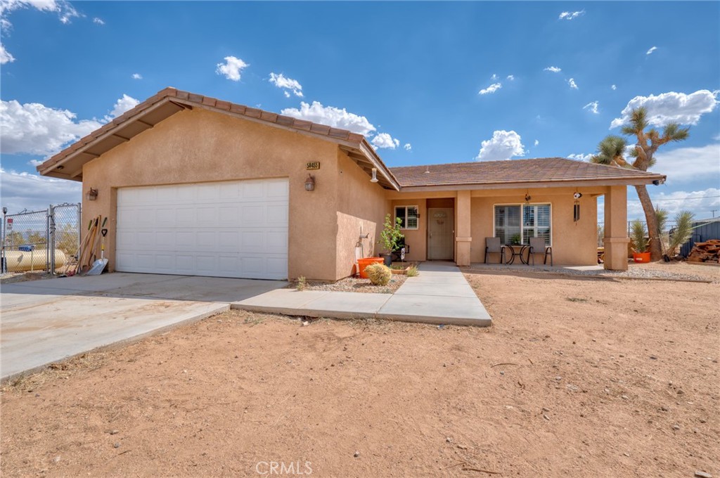 Welcome to your new home in the heart of the Yucca Mesa School area, where comfort and convenience meet the serene beauty of Yucca Valley. This spacious 4-bedroom, 2-bath residence offers 1,695 square feet of thoughtfully designed living space, perfectly situated on a generous 20,908 square foot lot.
Inside, you'll find modern touches like paid solar, recessed lighting, and ceiling fans, enhancing the home's bright, open floorplan. The kitchen is a chef's delight, boasting tile countertops, stainless steel appliances, and abundant cabinet space, making it the perfect spot to gather with family and friends.
Step outside to discover a yard that’s truly a haven for animal lovers, offering ample room for pets to roam and explore. The expansive outdoor space also provides endless opportunities for relaxation or entertaining under the wide-open desert skies.
Living here means you're just a short drive from the natural wonders of Joshua Tree National Park, where hiking, rock climbing, and stargazing await. The vibrant local community offers a mix of art galleries, unique shops, and dining options, ensuring there's always something new to discover. Whether you’re seeking a peaceful retreat or a base for adventure, this home offers the best of both worlds.