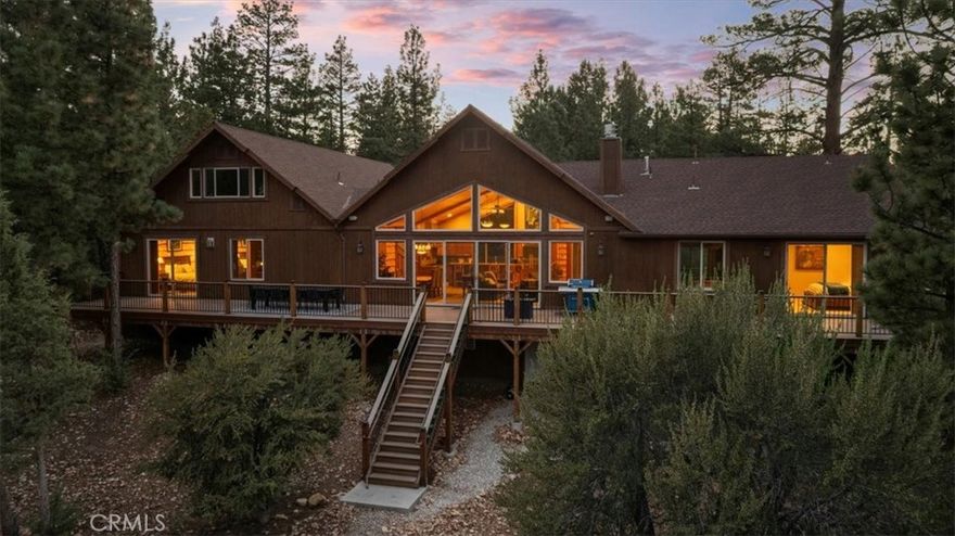 Stunning custom lodge-style home on 1.27 private acres in sought-after Meadowbrook Estates. Built in 2015, this 4,136 sq ft residence offers 4 to 5 bedrooms and 4.5 baths.Two spacious primary suites adorn separate wings of the home—each with spa-inspired en suite baths and private deck access. The great room greets you with vaulted wood-beamed ceilings, floor-to-ceiling windows, and a grand rock fireplace, creating a luxury Lodge style gathering space. The gourmet chef’s kitchen features Thermador appliances, natural-edge granite countertops, dual dishwashers, double ovens, wine fridge, casual bar height seating, and a giant walk-in pantry. A dedicated entertainment wing includes a game room, wet bar, full bath and a fully equipped 8-seat theater room with reclining chairs, projector, and sound system. The flex space of the entertainment wing with it’s full bath can double as additional guest quarters and the theater room could easily convert to an spacious 5th bedroom. Enjoy outdoor living on the expansive Trex deck with panoramic forest views—ideal for dining, relaxing, stargazing and roasting marsh mellows. Additional features: 3-car garage with EV charger, custom murals, and high ceilings, central A/C, Wi-Fi thermostats, surround sound, security system, extra large laundry/mudroom, and central vacuum. Nearly all furnishings can be included, making this masterpiece more than move-in ready. Ideal as a primary home, luxury vacation getaway, or income-producing rental/Air BNB.