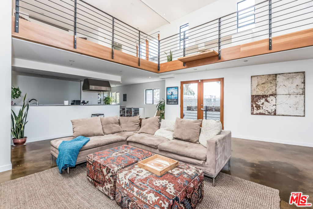 Chic loft in the heart of Venice overlooking Abbot Kinney. This corner residence has south-west exposure, 20-foot ceilings, modern concrete floors, and French doors that flood the space with natural light. One of the largest residences in the building, this home is complete with a spacious balcony with views of the neighborhood, rooftop deck, direct access garage, and a bonus room that can be used as a gym or office. Located a stone's throw from Main Street and the beach, this sun-drenched loft is Venice living at its best.