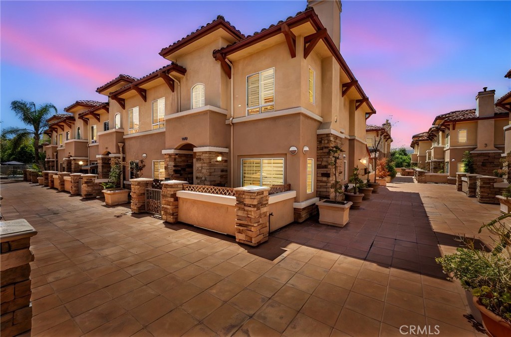 Beautiful end-unit townhome located in the gated Terra Grande Community. This tri-level townhouse which was recently renovated in 2023 has direct access to a lower gated garage with FOUR parking spaces that only this unit has. The extra room on the lower level is equipped with a full bathroom, closet, and storage area which can be used as an office, media room or bedroom. The main level features a living room with a cozy fireplace, 2 extra rooms and half bath. The updated kitchen with granite counters and island is adjacent to the dining area. The french doors leads to the covered back patio which is great for entertaining. The upper level has a large master suite with walk-in closet, bathroom with double vanity, and separate tub and shower. There are two additional bedrooms and a full bathroom. This private community includes a gym, pool and spa. Best location in West Covina, close to South Hills High School, restaurants and shopping centers. Must see! Ready to move-in!!
