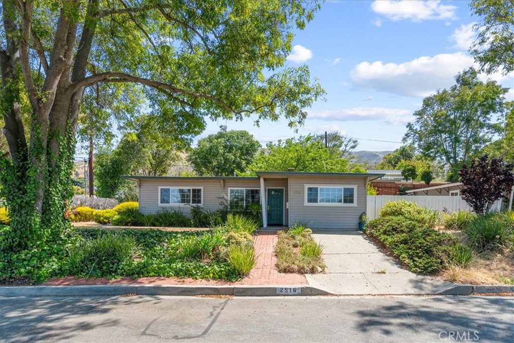 Welcome to this warm and inviting 3-bedroom, 1-bath home, ideally located on a spacious approximately 6,717 sq ft corner lot. The front room features a beautiful wood ceiling that adds character and charm, while large windows invite in natural light and views of the mature, thoughtfully landscaped yard.
Enjoy the convenience of an indoor laundry area and the charm of a cute gardening shed tucked away in the backyard — perfect for storage or weekend projects. A brick pathway leads to the front door, bordered by colorful plants and established greenery that enhance the home’s curb appeal.
Whether you're relaxing under the trees or digging into your next garden project, this home offers a serene, comfortable lifestyle in a lovely neighborhood setting.