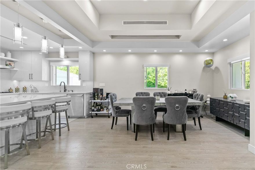 This beautifully fully remodeled 3-bedroom, 2-bath home combines modern design with everyday comfort. Step inside to an open-concept layout where the chef’s kitchen flows seamlessly into the dining and living spaces. The kitchen features sleek white cabinetry, quartz countertops, a spacious island with bar seating, and contemporary pendant lighting—ideal for both entertaining and casual family meals.
The dining area is framed by tray ceilings, recessed lighting, and large windows that fill the space with natural light, creating a bright and welcoming atmosphere. Elegant flooring runs throughout, complementing the home’s clean lines and modern finishes.
Good sized bedrooms, including a private primary suite, offer comfortable retreats with updated bathrooms featuring stylish tile work and fixtures. 
Junior ADU permits and drawings are available, it is approved and is ready for the new buyer to build.
Located in a desirable neighborhood, this home is close to schools, shopping, dining, and freeway access, making it the perfect balance of convenience and style.