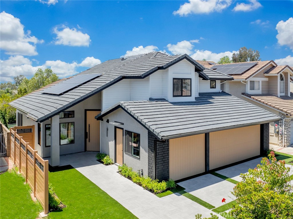 Presenting the pinnacle of Robison Ranch, this magnificent cul-de-sac property has been extensively upgraded. It now includes a permitted junior accessory dwelling unit (JADU), an additional 1.5 baths, a loft, and an expanded gourmet kitchen—adding approximately 500 square feet for a total of 2,613 square feet on of the largest home in the neighborhood. This eco-friendly home boasts top-rated energy efficiency and independence with recently added a fully paid-off solar system, a new energy-efficient air conditioning unit, a tankless water heater, double-glazed Energy Star windows, and new plumbing and electrical systems throughout the house.
This masterpiece features a modern façade, a unique driveway, and tactile finishes, complemented by a wood looking maintenance free fence and a floating entrance with a castle-style custom modern pivot door. The expansive layout seamlessly flows from formal and private areas to a stunning backyard with a well-designed BBQ area, modern pergola, fire pits, and a soothing waterfall. The designer powder room includes a ceiling-mounted faucet on a floating vanity, illuminated by modern pendant lights and hidden LED lights that draw attention to the decorative tile on the accent wall.
A beautiful addressable LED staircase leads to an upstairs loft with modern cable railing. The large master bedroom, with its vaulted ceiling and sound-insulated modern back paneling, features a large barn door opening to a master bathroom with a spacious walk-in shower, a relaxing Japanese jacuzzi tub with a dazzling view, and a well-planned water closet and master walk-in closet. The downstairs bedroom offers an ensuite bathroom and a sliding patio door for private outdoor access.
The JADU includes a kitchenette with an integrated sink and dishwasher combo, plus a private bathroom with a passageway to the main house—making it perfect as an independent suite or part of the main home. The new chef-grade kitchen features Dacor® built-in appliances, a gem-looking waterfall island with microwave drawer and wine cooler, and stunning modern LED lighting. The impressive high-ceiling living room and dining room connect to a pleasant family room with a marble slab stone fireplace with large opening onto a quiet custom design backyard.
The Robison Ranch community offers an unparalleled lifestyle with a private pool, playground, tennis, pickleball, basketball, and BBQ areas, along with easy access to top-rated schools, parks, shopping, and dining.