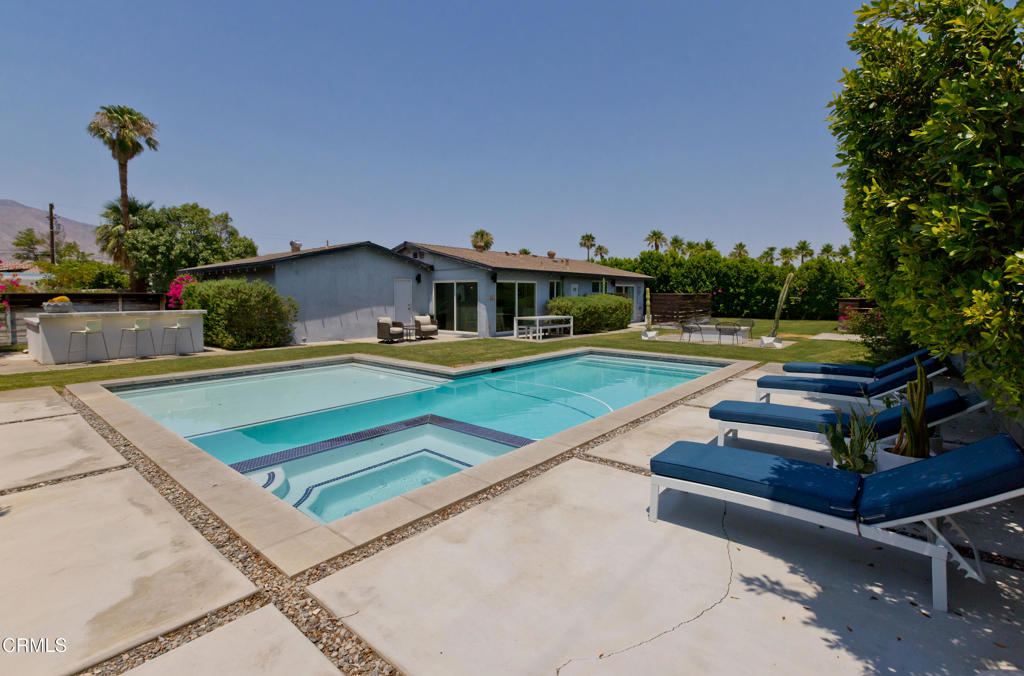 This warm and contemporary home offers 3 spacious bedrooms and 2 bathrooms, blending comfort with style. Just a couple of miles from vibrant downtown Palm Springs, you'll enjoy effortless access to acclaimed restaurants, boutique shopping, lively nightlife, casinos, championship golf courses, and the iconic Palm Springs Aerial Tramway. Whether you're entertaining or unwinding, the open floor plan and natural light create an inviting atmosphere throughout the home. Step outside to take in breathtaking views of the majestic San Jacinto Mountains--perfect for enjoying your morning coffee or evening sunsets. A perfect desert retreat that combines convenience, charm, and scenic beauty. Backyard features a large pool with Baja deck, spacious lawn, outdoor fireplace, and built in grill. FEE SIMPLE - No land lease.