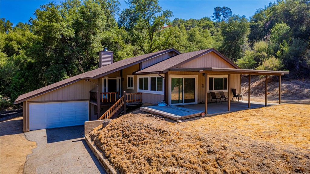 Drive through a country feel setting neighborhood with cows and horses. At the property there is a gentle upslope driveway offering views of mountain peaks, beautiful sunsets and occasional mountain deer. This single level home is turnkey, ready for you to bring your landscaping ideas and your creative touches. Walk into a living room with a Rustic Design inspired high wood beam ceiling. This home offers a large primary bedroom with a full bathroom, two good size guest bedrooms and a full bathroom in the hall. Newer flooring though-out, newer dual pane windows through-out, roof age 2011, granite counters in kitchen and bathrooms, central heating and air conditioning, newer kitchen appliances, neutral paint inside and out, two covered porches, front and back for your porch sitting. Attached two car garage on ground level with plenty of storage space. A recorded easement and map of survey that benefits this property to drive around back to park your boat or camping trailer on the property. Surveyor flagged. Possibilities to expand the back yard for a shop. Great for Short Term Rental, No HOA and water from Pikes Ranch mutual water company. One year home warranty included, cost limit applies. A must see!