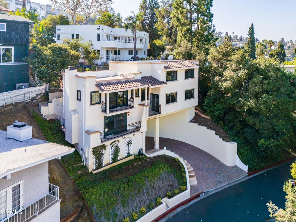 Built in 1985, this Mediterranean-style hillside home offers elegance, comfort, and some of the most impressive views in Glendale. With 3 bedrooms, 2.5 bathrooms, and 1,978 sq. ft., the multi-level design captures natural light throughout and opens to three balconies and a private patio overlooking Downtown Glendale and beyond. Interiors feature Venetian plaster walls, marble, and custom hardwood floors, complemented by chandeliers and decorative sconces that add a touch of timeless detail. The kitchen is equipped with a KitchenAid range and Thermador oven, while central A/C and heating ensure year-round comfort. Whether hosting guests or enjoying a quiet evening, this home blends Mediterranean charm with modern livability.Don't just imagine the lifestyle--come experience it. Schedule your private tour today and see why this hillside residence, with its panoramic city and sunset views, is one of Glendale's true treasures.