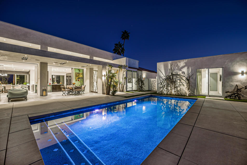 Discover unparalleled luxury in this stunning 4-bedroom, 6-bathroom estate perfectly positioned adjacent to the tee on the 14th fairway of Ironwood's prestigious North Course. Originally built in 1984, this home underwent a complete transformation in 2018, totally reimagined with exceptional craftsmanship, high-end materials, and modern functionality--offering the benefits of a nearly new home. Enter from the enclosed front courtyard into the expansive great room featuring soaring ceilings, recessed lighting, sliding pocket doors, a statement fireplace, and 24-inch slate tile floors throughout to enhance the home's elegant design. Upgraded windows and sliding doors paired with custom window coverings create views from nearly every location in the home. The gourmet kitchen is a chef's dream, quartz countertops, custom cabinetry, top-tier stainless steel appliances, wine chiller and a separate temperature controlled wine closet. The primary suite offers a true retreat with his and her bathrooms and a private office space. The two guest ensuite bedrooms have sliding doors to the patio areas. A detached guest casita provides an additional living area, wet bar, bedroom, and full bathroom--perfect for hosting guests in comfort and style.Designed for entertaining, this estate features a 29x30 foot second-floor observation deck with breathtaking panoramic views of the golf course and surrounding mountains. The resort-style courtyard is a private oasis, complete with a sparkling pebble tec pool, spa, fire pit, grill with dining area, and thoughtfully designed desert landscaping. Energy efficiency meets modern luxury with a fully owned solar panel system, significantly reducing utility costs. Meticulously designed with no detail overlooked! Experience luxury, elegance, and premium golf course living--schedule your private showing today!
