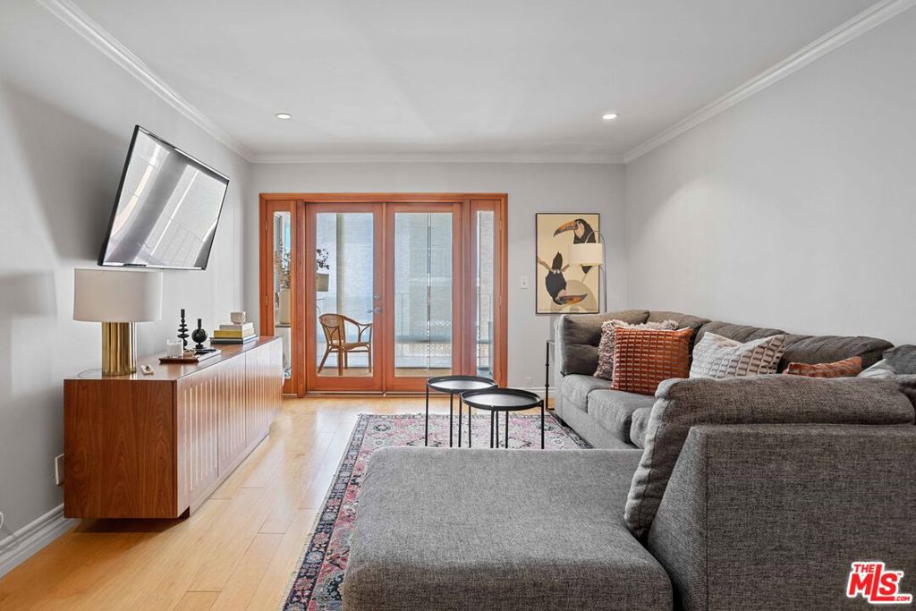 Live in the heart of West Hollywood, just one block from iconic Urth Caff and surrounded by the city's best restaurants, coffee shops, gyms, and high-end boutiques. This bright and spacious unit offers an open floor plan with hardwood floors, an bathroom and updated kitchen featuring an electric range, stovetop, dishwasher, and recessed lighting throughout. The oversized living and dining area flows seamlessly onto a large inclosed balconyperfect for morning coffee or working from home. The bedroom is generously sized with excellent closet space, and the unit includes central HVAC for year-round comfort. Situated in a controlled-access building with an elevator, secure garage parking, additional storage, and low HOA dues. Tucked on a quiet, tree-lined street just moments from Melrose Ave, Santa Monica Blvd, the Design District, Beverly Center, and Cedars-Sinai. It doesn't get better than this in WeHo.