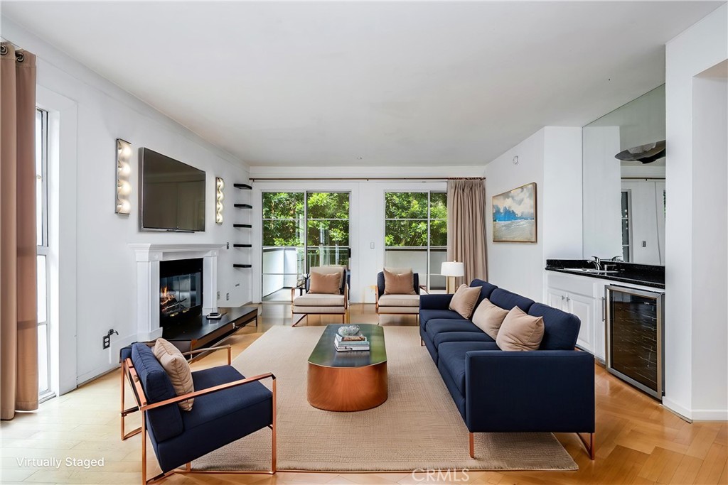 Light-filled and well-appointed 2-bedroom, 2-bathroom corner unit with approximately 1,525 square feet of living space, located in a prime Westwood cul-de-sac within a secure, controlled-access building. This desirable residence offers a smart layout and exciting potential, featuring high ceilings, a formal entry, and an open living and dining area complete with fireplace, wet bar, and sliding glass doors that open to a private patio—perfect for indoor-outdoor living. The well-designed floor plan includes a functional kitchen with granite countertops, a guest powder room, and two generously sized bedrooms, each with its own ensuite bath for added privacy. The oversized primary suite features a walk-in closet and a well-appointed bathroom with marble accents, a spa tub, separate shower, and dual-sink vanity—ready for your personal touch. Additional features include in-unit laundry, central HVAC, two tandem parking spaces in a secured garage, and a pet-friendly HOA. Ideally situated near UCLA, Westwood Village, Century City, and Beverly Hills, and located within the coveted Fairburn Elementary School district—with convenient access to the 405 and 10 freeways.