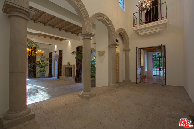 This Spanish Colonial with a rich Moorish influence is set in the heart of Serra Retreat. Behind gates, the Estate home offers 5 bedrooms/6 bathrooms and a separate guest suite with a private entrance and a spectacular pool. Beautifully detailed; there are stone floors, limestone countertops, custom tile & cabinetry and distressed beamed accents throughout. Many of the finishes were imported from Mexico and incorporated into elements of the home. The entry hall with cathedral ceilings opens to a magnificent living room. Beautifully detailed arched doorways lead from the living room to a pool area and expansive lawns surrounded by King palm trees & ferns. An entertainer's dream. The home is set in a perfectly groomed tropical setting. Truly one of California's exceptional properties.