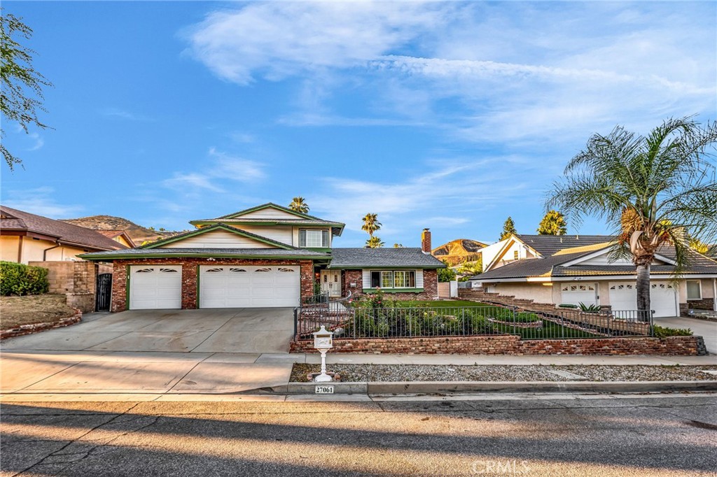 Tucked away on a quiet cul-de-sac in Saratoga Hills, this Calabasas home offers generous space, classic comfort, and a backyard that’s ready for your imagination. The main level features a traditional floor plan with a large family room and fireplace, separate living area, and formal dining space. The kitchen offers ample cabinet and counter space, a bay window, and a walk-in pantry. Downstairs also includes a bedroom and adjacent full bath—ideal for guests or a home office—plus a dedicated laundry room. Upstairs, you’ll find three more bedrooms, including a primary suite with a walk-in closet and shared full bath. The backyard includes a spacious patio, open lawn area with mature trees, and tons of outdoor storage for tools, gear, or seasonal items. Additional highlights include a three-car garage, central air, and a tankless water heater. Conveniently located near top-rated Las Virgenes schools, shopping, and 101 freeway access.