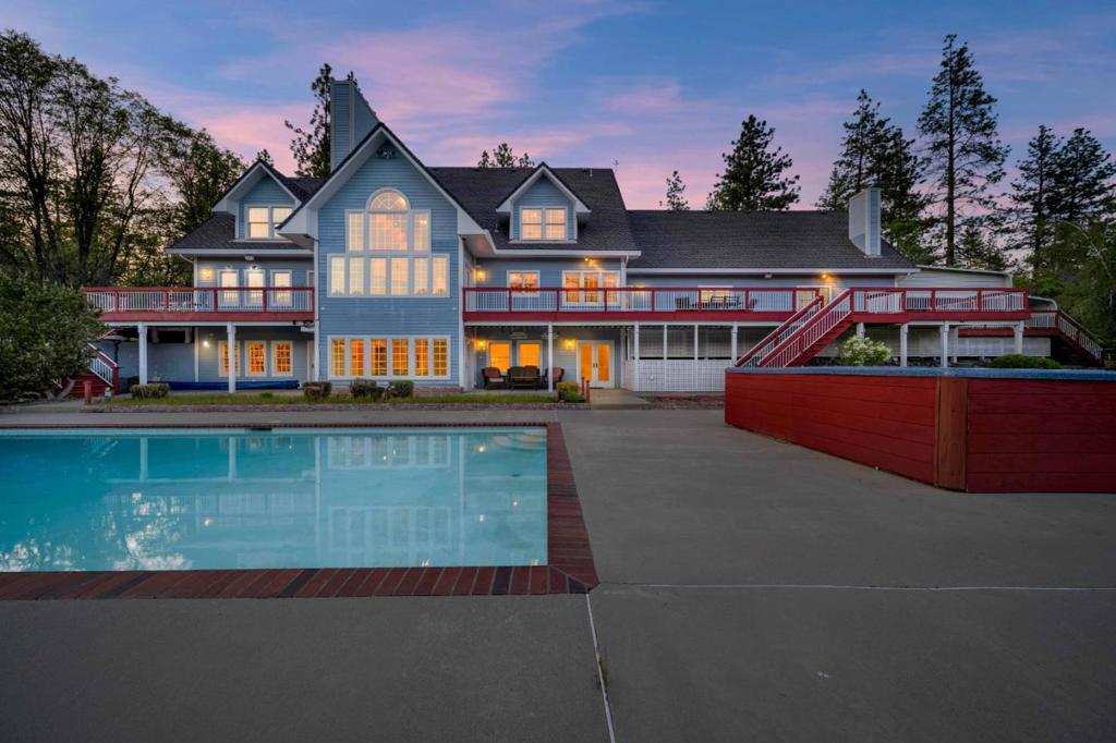 Welcome to your private 20.8-acre resort estate with jaw-dropping views of Mt. Shasta. This 6,600+ sq ft Victorian-inspired masterpiece includes 5 bedrooms + guest suite, 2 full kitchens, bonus rooms, and soaring ceilings. Entertain in style with a 20x40' pool, dual hot tubs, endless river, koi pond, outdoor tiki kitchen, and putting green with sand traps. Enjoy a custom cedar sweat lodge, outdoor tiki bathroom, helipad, 1,000 sq ft hangar/shop, and a seasonal lake with island bridge. Three wells, 6,000 gal. tanks, multiple septic systems, and propane infrastructure support this one-of-a-kind retreat. Interior features include oak floors, vaulted ceilings, fireplaces, stereo system, and central vac. Gated entry, surveillance, and 3-car garage with RV bay add convenience and security. Just 10 minutes to Yreka shopping, hospitals, and highways this is mountain-view luxury with total privacy and easy access to recreation, skiing, airports, and more. Truly one of Californias most unique lifestyle properties!