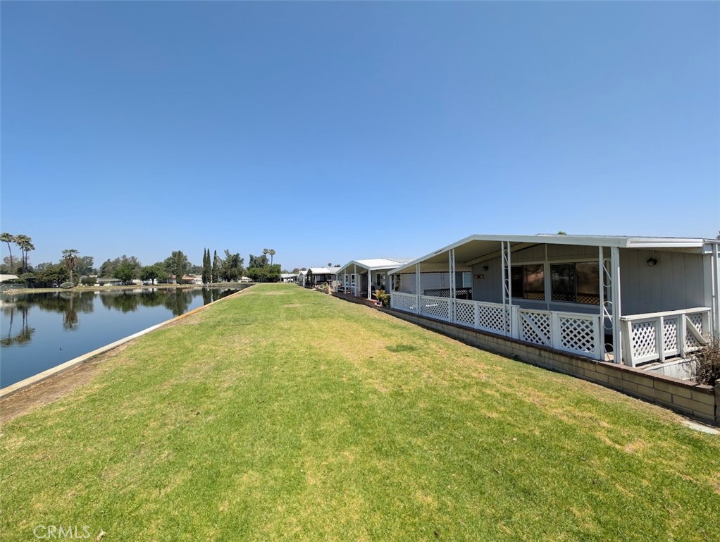 Lake front home. Two bedroom, 1 3/4 bath, large kitchen. laundry room, living room with attached dining area plus family room. Covered porch plus covered deck. Side-by-side parking for two cars. Two storage units. One of the best lake view properties in the park. This home is a FIXER. This is a 55 and over senior living community. Square footage not taped buyer to verify. Sold as-is. Buyer to verify space rent when they pick up their park application.