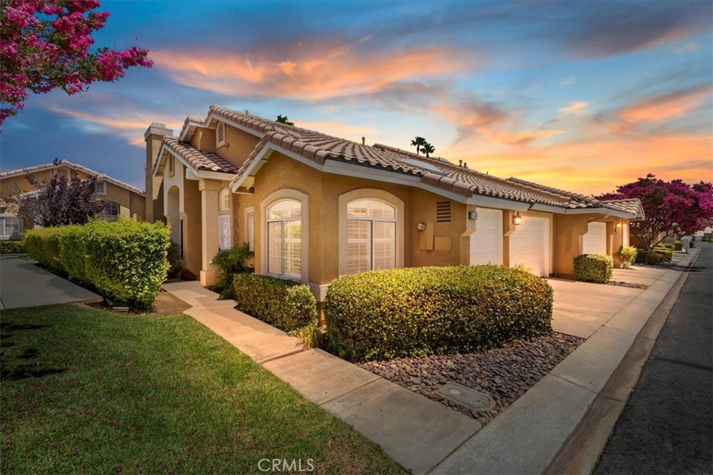 Bright & Airy 2 Bed, 2 Bath Home in Prestigious Sun Lakes Community! Welcome to resort-style living in the highly desirable Sun Lakes Community, where luxury, comfort, and convenience come together. This beautifully maintained 2 bedroom, 2 bath corner unit home offers a light-filled and open floor plan with shutters throughout, creating a warm and inviting atmosphere. Step into a spacious living room with a cozy fireplace, perfect for relaxing or entertaining. The dining area flows seamlessly into the large kitchen, which boasts ample cabinet space, recessed lighting, and an abundance of windows, including a charming sunroom area ideal for a breakfast nook or home office. The primary bedroom is generously sized and features a sliding glass door that opens to a tranquil backyard—with a gate that leads directly to one of the community’s many pools. The primary ensuite bath includes dual sinks, a walk-in shower, a walk-in closet, and an additional storage closet. The second bedroom offers a comfortable space for guests or hobbies. The home has been freshly painted inside and includes newer carpeting for a move-in ready experience. Enjoy all the amenities Sun Lakes has to offer, including golf courses, swimming pools, fitness centers, tennis courts, a clubhouse, and an on-site restaurant. Conveniently located near shopping, dining, entertainment, and the I-10 freeway, this is 55+ living at its best!