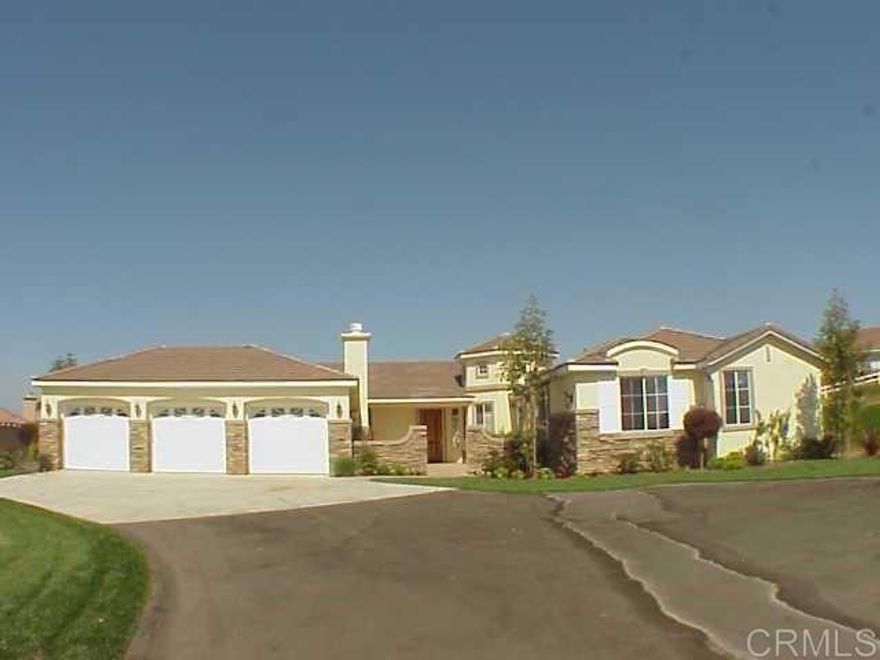 Discover the perfect blend of luxury, comfort, and serenity in this exceptional single-story residence nestled on over an acre of land. With 3 spacious bedrooms, a dedicated office, and 3.5 beautifully appointed bathrooms including dual master suites. This 3,160 sq ft home offers ample space for both relaxing and entertaining.The chef’s kitchen is a true centerpiece, featuring high-end appliances, formal and casual dining areas, and a seamless layout that invites gatherings of any size. Step outside to enjoy panoramic mountain views, incredible sunsets, while relaxing in your courtyard complete with a built-in fireplace — perfect for cozy evenings under the stars. The expansive backyard offers even more space to entertain, featuring a built-in BBQ, lush landscaping, and fruit trees that add charm and flavor to your everyday. Located just minutes from town yet offering the tranquility of country living, this home truly captures the best of Fallbrook. Schedule your private tour today and experience Fallbrook living at its finest!