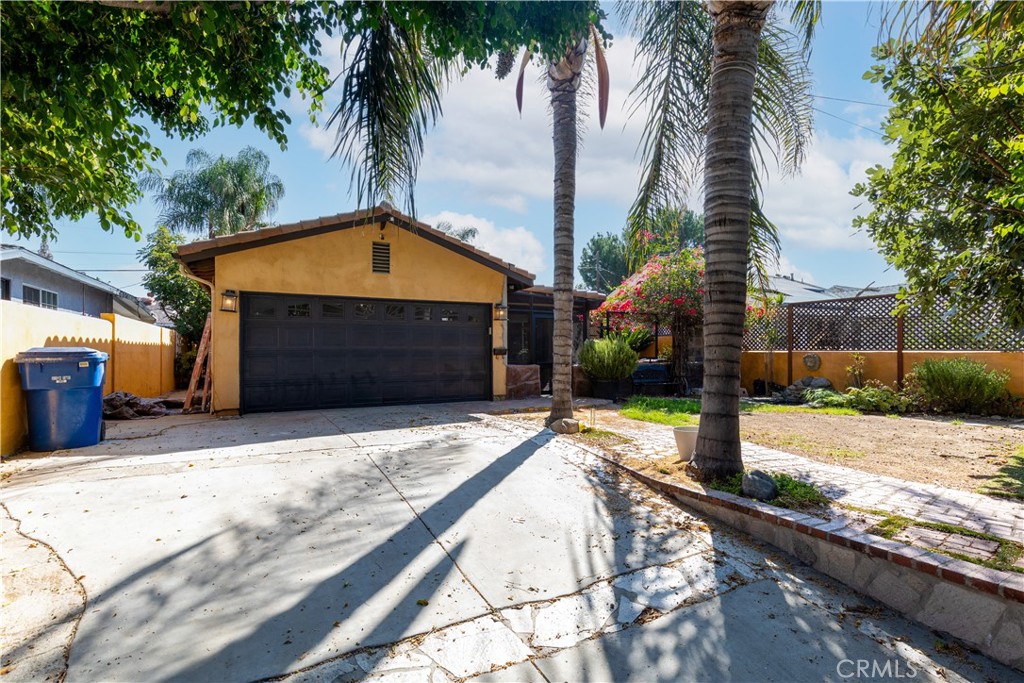 This Spanish-style home offers the perfect blend of luxury and comfort in a meticulously crafted three-bedroom, three-bath layout. Every room has been thoughtfully customized, from the rich hardwood floors to the unique architectural details that make this property truly stand out.
The living room features an open-concept design with soaring ceilings and a striking beam that ties the space together. A custom fireplace adds warmth and elegance, while the adjacent chef’s kitchen includes custom cabinetry, a Viking semi-stove, Viking electric built-in oven, and stainless steel dishwasher—ideal for everyday living and entertaining.
The primary suite boasts a spa-inspired bathroom with a custom Canyon-style bathtub. Two additional bedrooms share a beautifully renovated Jack-and-Jill bath. A hidden room provides the perfect flex space for a den or office or 4th bedroom.
The garage has been transformed into a fully equipped workshop, Outdoors, a custom-built pizza oven sets the stage for gatherings, while the front yard welcomes you with Portuguese tiles, a charming patio enclosure to keep your furr-Babies safe. Plus, the home comes equipped with solar panels for energy efficiency and savings.