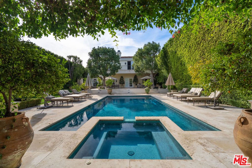 Elegant Mediterranean-style villa is located in the coveted Beverly Hills flats. This flawless 7 bed, 9 bath family home boasts high ceilings, a grand entry with a dramatic circular staircase, imported Italian limestone flooring, a gourmet kitchen complete with high-end appliances, and a walk-in pantry. The massive primary suite is complete with double baths and designer closets. The pool is surrounded by park-like grounds and a two-story guest house.