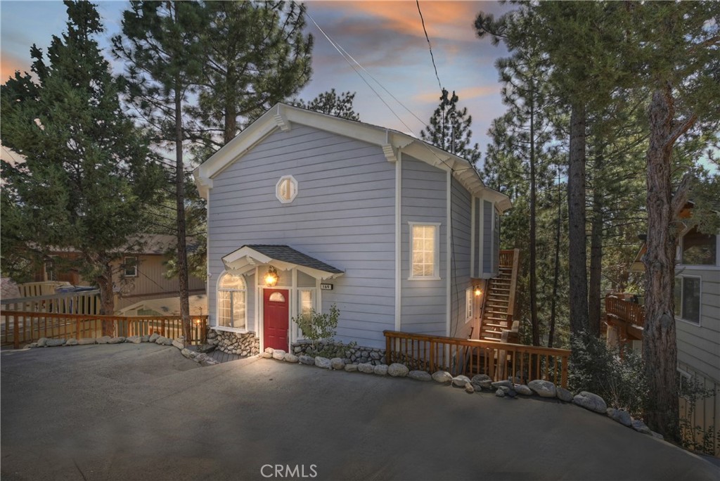 IF UNIQUE IS WHAT YOU SEEK... Wait until you see the "Mountain Theme-Park" finish in this custom 3-bedroom, 2-bath lodge-style home. It features high vaulted ceilings, an impressive floor-to-ceiling rock fireplace, a custom wet bar with refrigerator, knotty pine cabinetry, and real pinewood plank flooring. The home also features a large built-in dining area, a full-size laundry/mud room, central heating, and a central vacuum system. Additionally, all interior walls are insulated for sound. Enjoy a huge deck off the living room as well as smaller covered decks off the bedrooms. There’s also a spacious sub-area that can accommodate additional square footage, all situated on a well-treed 50' x 100' lot that feels like living in a tree house. This is one property you have to see to believe!