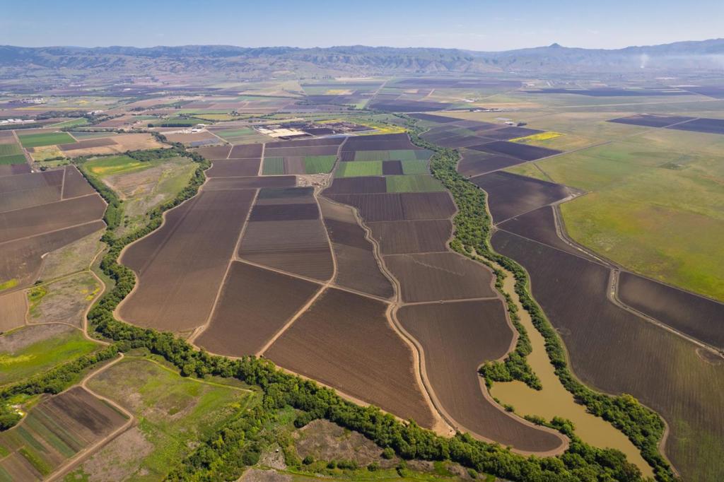 The Sargent Ranch is a large, prime agricultural property located at the confluence of the Pajaro River and the Carnadero Creek, and with 523 usable acres, the Sargent Ranch represents one of the largest remaining holdings of prime farmland in Santa Clara County. This ranch is within an intensively cultivated farming region that benefits from prime level soils and an abundant supply of water, in a location with the ability to grow all the fresh vegetable crops similar to the north end of the Salinas Valley and the Pajaro Valley. Five irrigation wells provide water to the 493 net acres through a underground high-pressure PVC lines, and the ranch is further improved with drain tiles to assist in moving water off the ranch during the winder months. The ranch is leased to a single, long-term tenant through October 31, 2025, who is extremely familiar with the property and is interested in staying on beyond the current lease term.