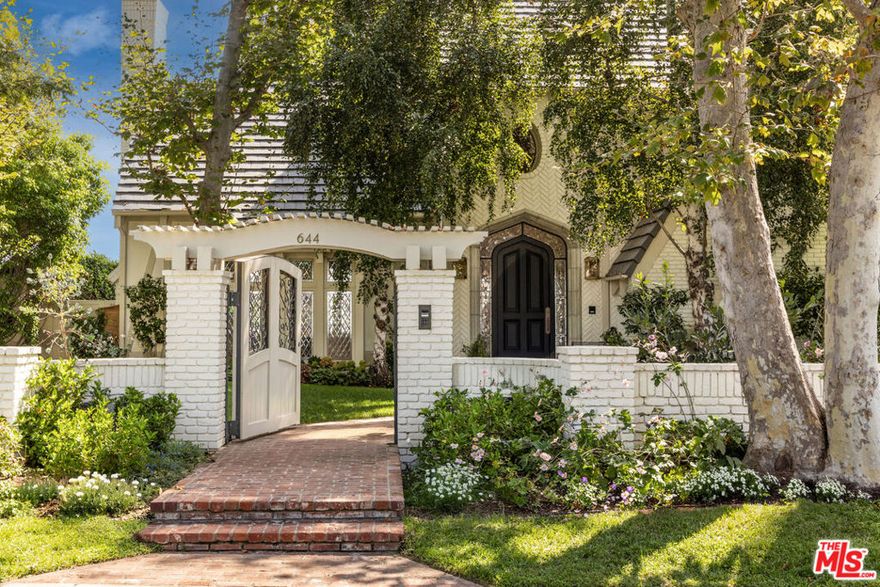Spectacular gated English estate on coveted Amalfi Drive in the Palisades Riviera. With sweeping ocean, canyon, and country club views, this 5-bedroom, 5.5-bath residence has been reimagined to balance timeless character with modern luxury. Every detail reflects the exquisite renovation, where elegant finishes and authentic charm define the home. A garden arbor and beautiful entry lead to a dramatic two-story foyer. The living room showcases vaulted wood-beam ceilings with woven cane inlay, a limestone fireplace, and leaded glass windows opening to a private view patio. The formal dining room with French doors flows into a gourmet kitchen with a large center island, top-of-the-line appliances, and a sunlit breakfast alcove overlooking the garden. Designed for entertaining, the family room with French doors highlights panoramic views and is fit with a masonry fireplace, custom banquette, and built-in media center. A paneled den with fireplace creates an ideal retreat, while a guest suite, elegant powder room, mudroom, and laundry complete the main level. Upstairs, the primary suite features a fireplace, sitting area, dual closets, and private balcony with breathtaking views. The spa-like bath offers heated stone floors, custom millwork, a ribbed glass steam shower, and a luxurious soaking tub. Two additional en-suite bedrooms, and a playroom with vaulted ceilings complete the second story. A private guest wing with bath and walk-in closet provides flexibility. Venture outside to enjoy beautifully landscaped grounds with mature trees, bluestone patios, a built-in barbecue with entertainment bar, a garden house, and deluxe pool and spa all framed by sweeping vistas. Wide-plank floors, Savant home automation, integrated A/V, Lutron lighting, upgraded systems, and water filtration complete this exceptional home. Just moments from the beach, local shops and restaurants, top-tier schools, Rustic Canyon Park, and Brentwood Country Mart, this one-of-a-kind estate is a truly rare offering for your most discerning  clients.