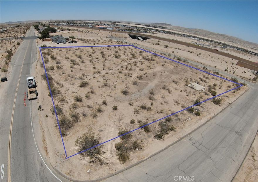 Great corner lot just off the freeway. Almost 2 acres of flat land. Build your DREAM HOME here!!  With water access right on the corner and homes near by. Three sides of this property are paved roads. Church St, K St and a cul-de-sac Apache Ave. There are 2 other properties on Apache also for sale.