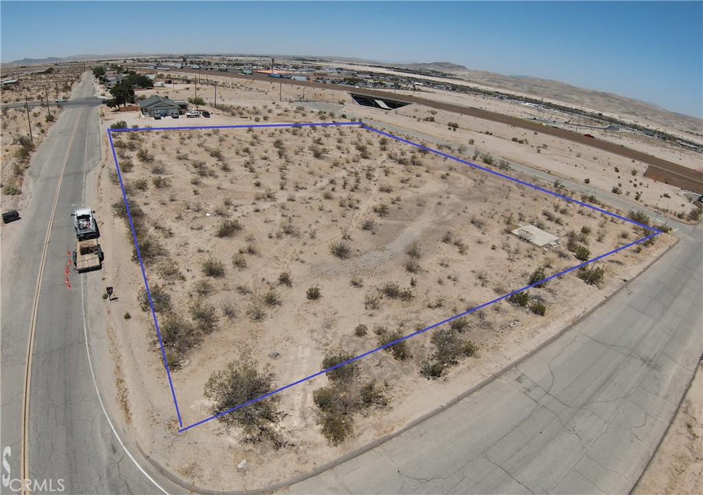 Great corner lot just off the freeway. Almost 2 acres of flat land. Build your DREAM HOME here!! With water access right on the corner and homes near by. Three sides of this property are paved roads. Church St, K St and a cul-de-sac Apache Ave. There are 2 other properties on Apache also for sale.