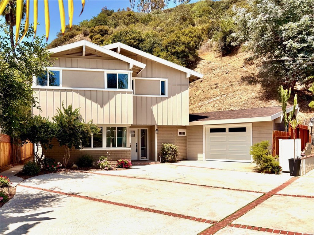 Nestled in the prestigious hills of Bel Air, this luxurious residence boasts a harmonious blend of elegance and modern comfort. This completely renovated residence, so close to the lush rolling landscape and cityscape views, beckons your presence . Here, you can relax in style or entertain guests, surrounded by the serene beauty that defines this exclusive neighborhood. Tucked away on a short shared driveway just off the main street, 2400 Nalin reflects the refined lifestyle and luxury living. As you enter, you will feel the beautiful new wide plank luxury vinyl flooring throughout this very expansive floorplan. The living room is very large and such a great space for entertaining with a large fireplace as the focal point of this room. A formal dining room sits next to the kitchen and features a space with built in cabinets and countertop and opens up to the cozy backyard space. This custom styled kitchen will make any chef happy with a large working area, new quartz countertops, stainless steel appliances and small sitting nook, next to the rear door. The laundry room is conveniently located in the adjacent room. As you move upstairs, you can see the very large Primary Bedroom, with large walk in closets, stunning en suite bathroom with huge walk in shower, soaking tub and dual vanities. Two other spacious bedrooms just down the hall. With its blend of natural beauty, luxurious amenities, and future potential, this property is an exceptional opportunity to experience the best of Southern California living. Don't miss this best priced Bel Air property.
