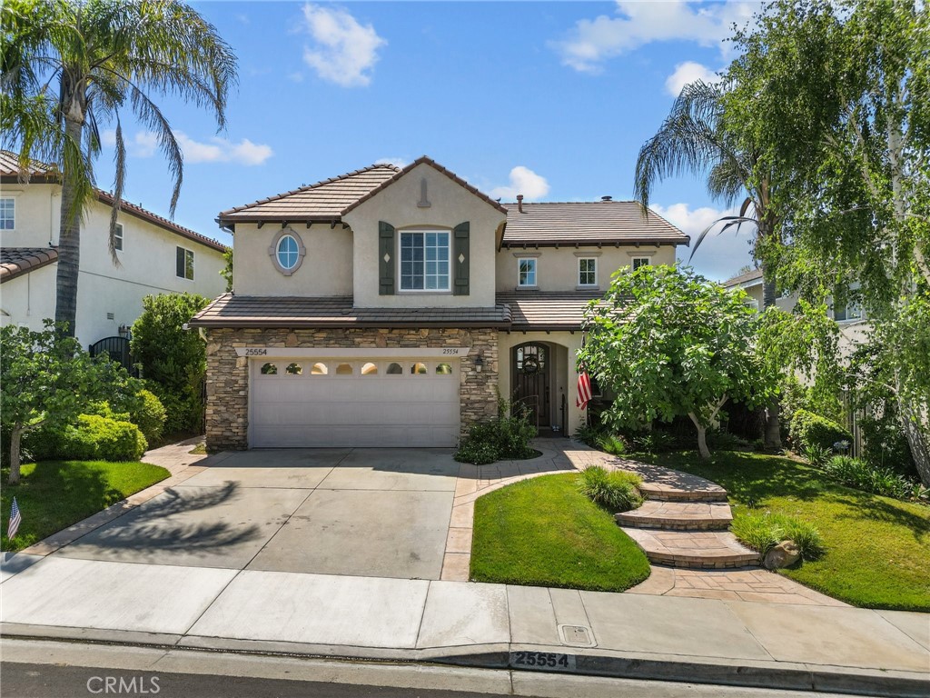 Welcome to this stunning 4-bedroom, 3-bathroom home boasting 2,826 square feet of living space at 25554 Housman Place, Stevenson Ranch. Step into a grand entry that opens into a spacious formal living room with a combined dining area, perfect for entertaining. The large chef's dream kitchen features Thermador appliances, a large center island, custom cabinets with a wine refrigerator, overlooking a cozy family room with a fireplace, ideal for gatherings and relaxation. All four bedrooms are located upstairs, including a generous primary suite offering double sinks, a separate tub, a walk-in shower, and a sizable walk-in closet. The spacious backyard with a wonderful view is complete with a private patio and grass area for the kids or entertaining guests. This residence offers not only practicality with its layout and amenities but also a comfortable and inviting atmosphere for both daily living and hosting friends. The home is situated in a highly desirable location with easy access to the freeway, making commuting a breeze. Discover the perfect blend of space, functionality, and convenience in this Stevenson Ranch gem and enjoy access to top-rated schools, parks, and community amenities, making it an ideal place to call home. Don't miss the opportunity to own this exceptional property in the Santa Clarita Valley. Schedule your private tour today!