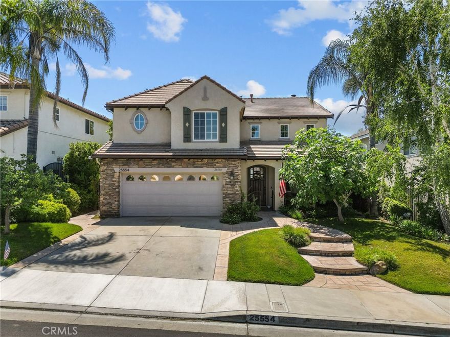 Welcome to this stunning 4-bedroom, 3-bathroom home boasting 2,826 square feet of living space at 25554 Housman Place, Stevenson Ranch. Step into a grand entry that opens into a spacious formal living room with a combined dining area, perfect for entertaining. The large chef's dream kitchen features Thermador appliances, a large center island, custom cabinets with a wine refrigerator, overlooking a cozy family room with a fireplace, ideal for gatherings and relaxation. All four bedrooms are located upstairs, including a generous primary suite offering double sinks, a separate tub, a walk-in shower, and a sizable walk-in closet. The spacious backyard with a wonderful view is complete with a private patio and grass area for the kids or entertaining guests. This residence offers not only practicality with its layout and amenities but also a comfortable and inviting atmosphere for both daily living and hosting friends. The home is situated in a highly desirable location with easy access to the freeway, making commuting a breeze. Discover the perfect blend of space, functionality, and convenience in this Stevenson Ranch gem and enjoy access to top-rated schools, parks, and community amenities, making it an ideal place to call home. Don't miss the opportunity to own this exceptional property in the Santa Clarita Valley. Schedule your private tour today!