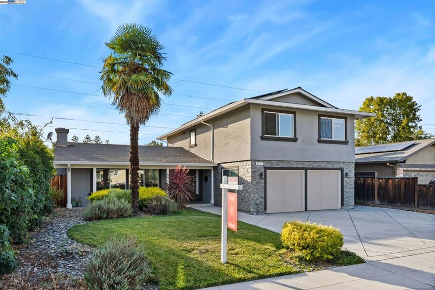 Beautifully remodeled inside and out, this stunning home shows like a model with an open-concept floor plan perfect for entertaining, vaulted living room ceilings with fireplace, separate family room with abundant natural light. Upgrades include newer energy-efficient dual-pane windows, updated electrical and plumbing, paid off solar with 2 batteries, EV charger, newer HVAC system, and a tankless water heater. The kitchen features elegant quartz countertops, large island, gas stove/oven, stainless steel appliances, two tone modern cabinets and views of the spacious backyard. The primary bath offers a large tiled shower with glass enclosure and heated tile flooring. Additional highlights include wood flooring throughout, motion-sensor lighted closets, epoxy-coated garage flooring, new driveway, and fresh front landscaping. The exceptionally large backyard features a fire pit, new grass, and plenty of open space ready for your personal touch. Conveniently located near downtown Livermore’s vibrant shops, restaurants, and wineries, with easy access to ACE Train and Highway 84 for a smooth Silicon Valley commute.
