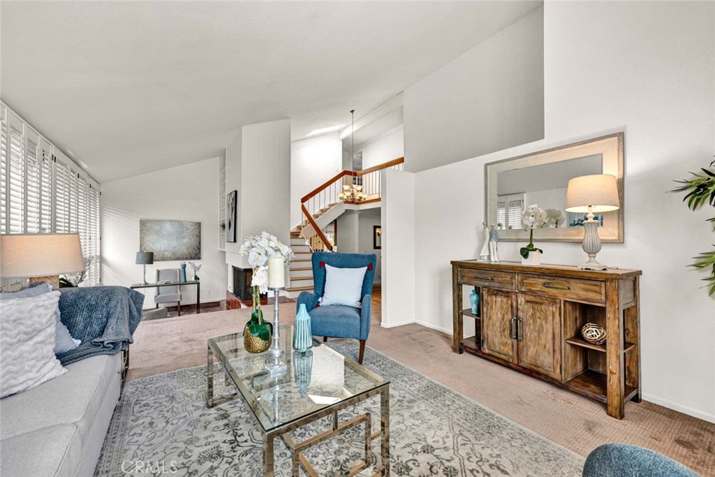 Welcome to this spacious 4-bedroom, 2.5-bath home offering 2,243 sq. ft. of comfortable living in the highly desirable Tustin Meadows community. Step inside to soaring ceilings and an open layout filled with natural light. The inviting living room features a cozy fireplace and a charming nook, perfect for relaxing or reading. The bright kitchen features stainless steel appliances, granite countertops, and rich wood cabinetry, with large windows overlooking the yard. A breakfast bar provides additional seating and flows into the generous family room complete with custom built-ins. Sliding doors lead to the large beautifully landscaped backyard with a covered patio, perfect for entertaining, summer barbecues, or evenings under twinkling lights. The downstairs has beautifully refinished hardwood floors and is complete with a convenient half bath. Upstairs you’ll find four spacious bedrooms and two full bathrooms, including the primary suite with high ceilings, a walk-in shower, and ample closet space. Enjoy all that Tustin Meadows has to offer, including two community clubhouses, pools, parks, playgrounds, and neighborhood events... all with a low HOA! Centrally located near The District, Marketplace, and schools, this home combines comfort, convenience, and community living.