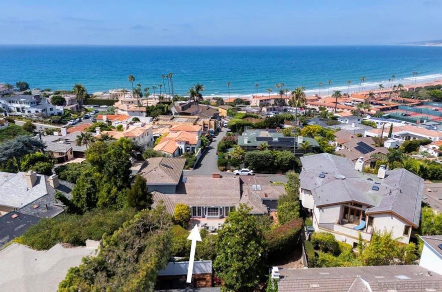 Homes in this sought-after location rarely come to market! With glorious whitewater coastline views to the rugged North Shore, this a highly coveted site just above La Jolla Shores with a beautiful, classic residence just steps to the La Jolla Beach & Tennis Club and Shores Village shops and restaurants. Private grounds are spacious and bright bay windows, gleaming hardwood floors, a wonderful staircase with handcrafted custom wood banister, and fresh woodwork and cabinetry provide a perfect backdrop for your style. A soaring natural wood open-beam ceiling with fireplace and windows opening to the expansive patio and mature gardens, and while friends and family will naturally gravitate toward the sea side views of the residence, the serene and spacious back patio offers another relaxing spot for dining and entertaining al fresco. The primary bedroom offers panoramic views-- a dream!