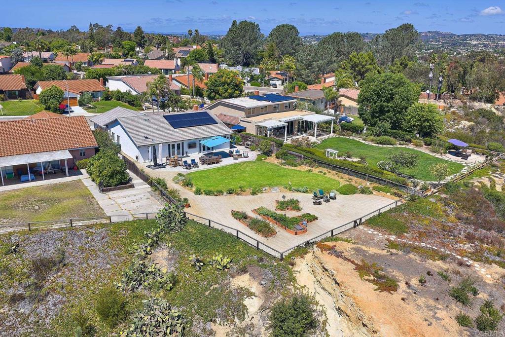 Rare opportunity with unmatched panoramic views over Olivenhain, Rancho Santa Fe and to the east, south and north. Homes on the east side of Trailview Road offer these sweeping views and command premium prices, and once you stand in this backyard gazing over Olivenhain, Rancho Santa Fe and beyond, you’ll understand exactly why. Featurning one of the largest usable yards in this sought-after neighborhood, along with truly breathtaking views. From sunrise to moonrise, endless 180-degree panoramas. Evening brings its own particular magic, as “golden hour” light illuminates the sky and window reflections as the sunsets. Flip the switch and lights shine on the bluff just beyond the fence. It’s a setting photos simply cannot capture – you must experience it in person to understand how magnificent it really is. Skylights in the over hang and water fountain creating a welcoming ambiance. Inside, skylights and solar tubes bathe the home in gorgeous natural light. You’ll love the inviting, open floorplan, with chef’s kitchen where the the atrium has been converted into a walk-in pantry with freezer, and the fifth bedroom (once a nursery or office) is now an oversized closet off the primary suite. Move easily through the French doors into the backyard – an entertainer’s dream, perfect for large gatherings, intimate evenings, and relaxing family time. Dine al fresco while cheering on the Padres on the outdoor TV. Release your inner gardener with raised garden beds for fresh organics, with drip system. 2 years ago upgrades include a new roof, fully paid solar, Nest-controlled heating and AC, a whole-house fan, ceiling fans in every room. Village Park offers very low HOA fees only $50 a monthwith a clubhouse pool, plauground, tennis courts, and grassy areas/parks. Short distances to Park Dale Lane Elementary and Diegueño Middle Schools and convenient to La Costa Canyon High School. Short drive to shopping, dining, freeways, beaches, hiking/walking/bike trails, and golf. Yes, lot is larger than the tax rolls state--ask your realtor about it the lot size.