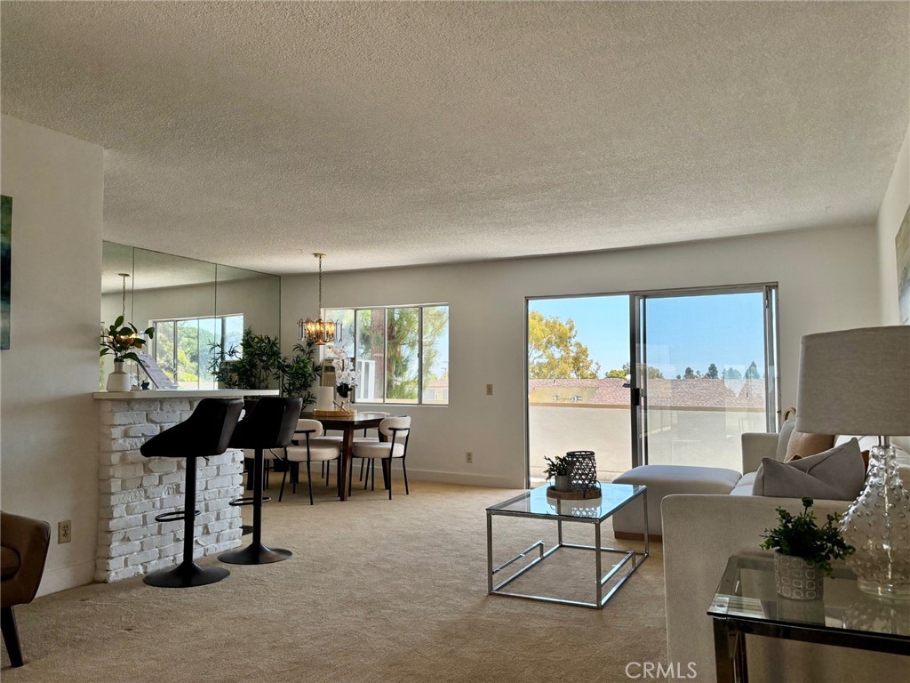 Experience the convenience of living on the Palos Verdes Peninsula in this comfortable, light & bright 2 bed | 2 bath single level condo that’s been updated with fresh paint, carpet and vinyl plank flooring in the kitchen & baths. This idyllic, corner unit is located closer to the back of the building providing a nice quiet atmosphere with tree tops as part of your view. You can enjoy your morning routine from the balcony right off the open concept living areas. Located in a secure building, this unit comes with its own parking space complete with a storage locker in a secure garage. Complex amenities include a pool, elevator, community laundry room on each floor and secured entry. Part of the award-winning Palos Verdes Unified school district and so close to the Peninsula Center and all the shopping there.