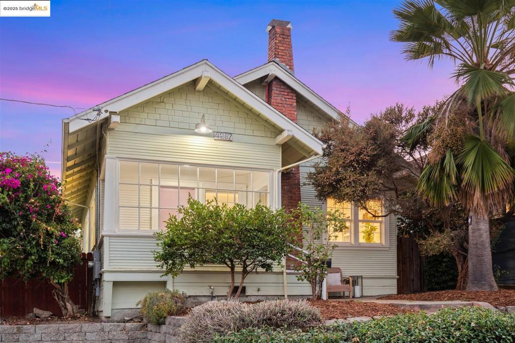 Built in 1911, this Craftsman lives larger than its 962 sq ft! This 2BD/1BA home blends period details with thoughtful updates. Enter through the enclosed front porch into a bright living room that flows into the dining area, complete with original box beam ceilings, a charming fireplace, and hardwood floors. The updated kitchen is open and well-designed, offering ample counter space and storage. Both bedrooms feature soaring ceilings, and the bathroom has been beautifully remodeled for the sale. Additional upgrades include updated electrical wiring, new lighting fixtures, fresh interior paint & solar panels. Laundry is conveniently located on the enclosed back porch. BONUS: A detached cottage with a lofted bed adds flexible space—perfect for a home office, creative studio, or guest hangout. The sunny backyard is a private retreat with mature landscaping, fruit trees, and plenty of room to relax. All this, tucked into a close-knit neighborhood, loved for its community feel, nearby parks, local shops, and easy access to commuter routes.