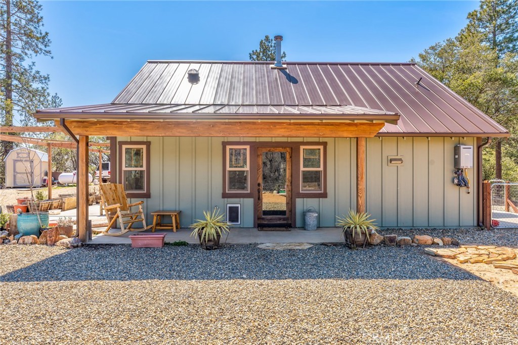Small is Beautiful – Off-Grid Mountain Living with Big Views
If you're drawn to independence, solitude, and natural beauty, this artist-designed home offers a rare opportunity for off-grid living just 15 minutes from Mariposa. Perched on 20 private acres with breathtaking Sierra views, this newly completed 1,000 sq ft residence combines sustainable living with upscale finishes and thoughtful design.
Set amidst the pines with fresh mountain well water and a state-of-the-art 20-panel solar system, the home blends seamlessly into its surroundings with optimal orientation for sunrise and sunset. Every room offers outdoor access and sweeping views, while the high ceilings and open-concept layout create a bright, airy atmosphere.
The 2-bedroom, 2-bath floor plan is perfect for vacationing couples or full-time living, with excellent privacy between bedrooms. Highlights include:
Custom rustic alder cabinetry, wide-plank butcher block countertops
Upscale tilework and vanities in both bathrooms
High-end appliances, modern lighting, and wood-look vinyl plank flooring
Spacious pantry, laundry area, and generous storage
Enjoy a strong indoor-outdoor connection with a large covered front porch and two expansive patios—one fully fenced for children or pets. A separate 4-acre fenced zone with an electronic gate provides additional security and ample space for larger animals.
The property is completely off-grid with robust systems, including:
Owned propane tank
10kW Generac generator
On-site well with 2,500-gallon storage tank
On-demand water heater
Fiber optic internet availability
Wood stove with rock hearth and whole-house furnace backup
Additional features include an 8'x10' storage shed, an 8'x8' woodshed, an insulated battery shed, freshly grated gravel driveway, and a large bear-proof garbage box repurposed from Yosemite National Park.
This is your chance to own a peaceful, private retreat with modern comforts and rugged charm.