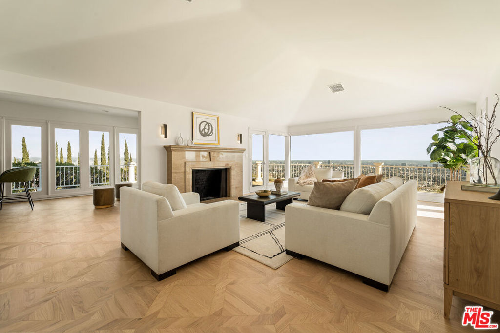 Available immediately: Presenting a spectacular view estate perched above the famed Sunset Strip with incredible 270-degree views, among the very best in LA, that stretch from downtown to the Pacific. Up a gated, private driveway, the property wraps around its own promontory to provide dazzling vistas from multiple vantage points, balconies, patios, and nearly every room. Enjoy the pleasure of optimal indoor/outdoor flow from the foyer, bar/salon, formal living room, dining room, and bedrooms, each opening to a vast wraparound terrace. Dine-al fresco, entertain under the stars, or lounge poolside amidst striking panoramas that must be seen to be believed. The primary suite includes a bathroom with jetted tub, separate glass shower, and dual-sink vanity, giving way to a bonus living area, gym, or dance studio with skylights and fireplace.The kitchen is replete with custom cabinetry and cooktop with hood. A nearby breakfast room connects to the guest wing which was previously a separate structure and has been adjoined to the main house to create a shared lounge with patio access. This additional living space offers its own separate patio, fireplace, wet bar, dining area, and kitchen. Welcome to an incredible location just moments to the area's very best shopping, fine dining, entertainment, nightlife, and so much more. Also available for sale.
