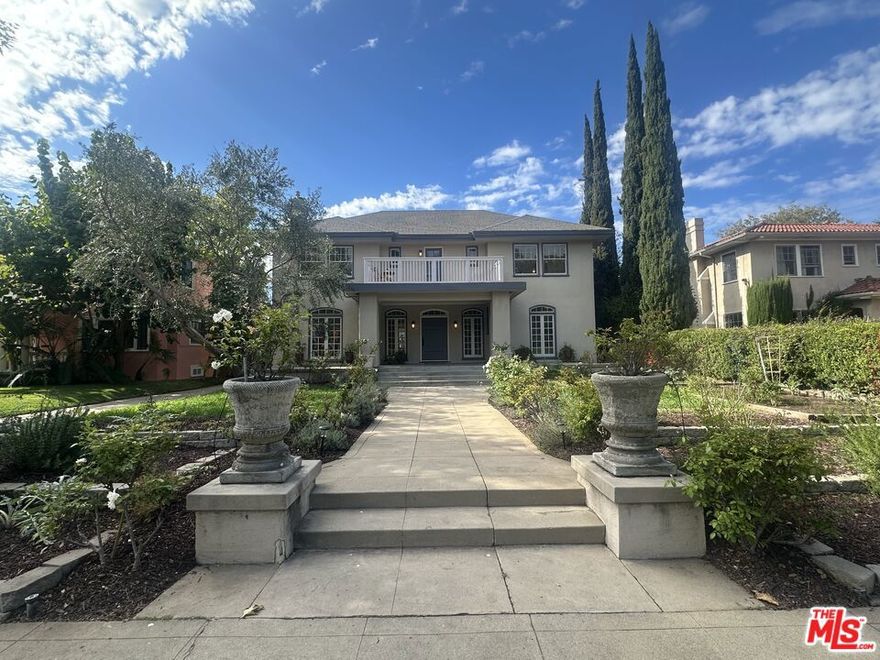 Photos to be uploaded by Saturday, 10/11/25!  Welcome to this Contemporary Italian Mediterranean, perfectly located smack in the center of historic Lafayette Square. Filled with warmth, light, and character, this 6-bedroom, 4-bath offers the ideal blend of timeless Italian charm and comfortable American living.  A wide, covered front porch invites you in, leading to bright, airy rooms and lovely details. The spacious layout comprises a sunroom, a generous office, and two en-suite bedrooms, including a serene primary suite with its own fireplace perfect for cozy evenings at home. A large upstairs balcony overlooks the neighborhood, ideal for a relaxing drink and greeting friendly, passing neighbors. A 3rd floor loft/bedroom/rec. room gives the home the feel of a large, 3-story Italian estate, complete with huge closet/storage area.  Outside, discover a magical Tuscan / Mediterranean garden retreat bursting with life! Lemon, pomegranate, apple, apricot, blood orange, and fig trees are complimented by grapes, artichokes, rosemary, and cheerful morning glories. Dine under the grapevine-covered pergola, listen to the gentle fountain, or enjoy a friendly game on the Bocce Ball court. With a rare four-car garage and side garden this home offers both charm and practicality, an incredible place to grow up, retire or just live the LA lifestyle of indoor/outdoor entertainment with a dash of Italy!