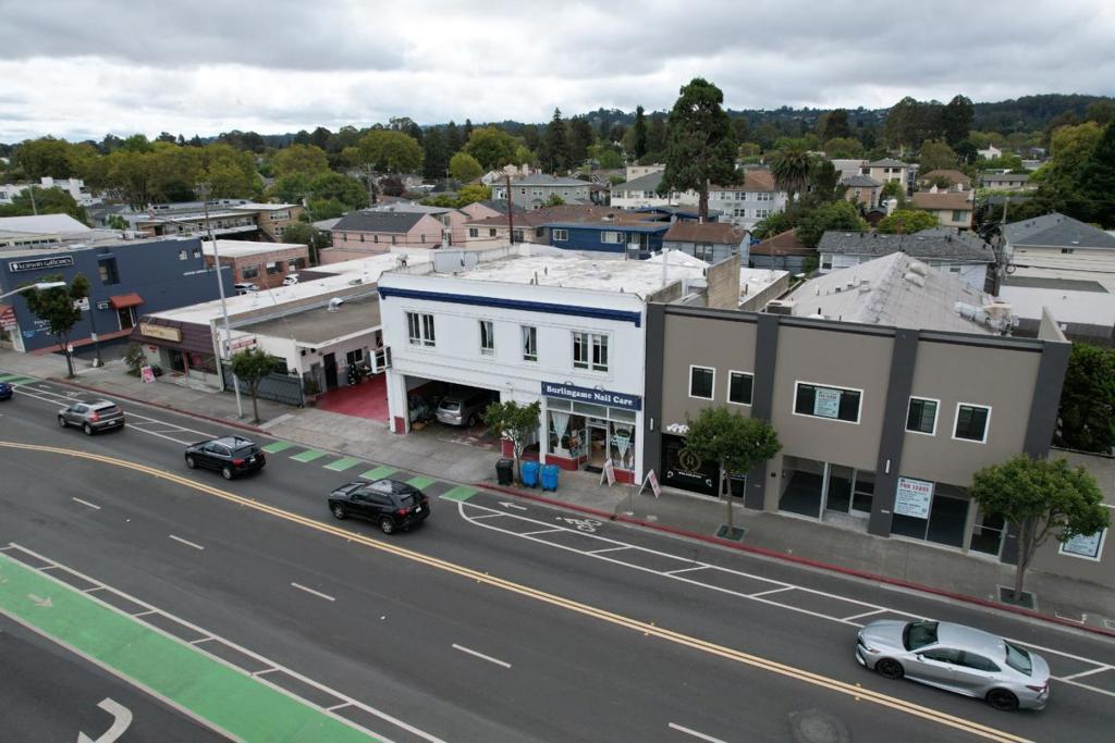 Pleased to present the opportunity to acquire 1131-1137 California Drive, a two-story mixed-use building located in the heart of Burlingame, California. This approximately 8,034 square foot property, built in 1962 on a 5,750 square foot lot, features a blend of commercial and residential spaces, offering stable in-place income with upside potential. The ground floor is fully leased to two established retail tenants: a nail salon (Burlingame Nail Care) and an auto body shop, providing reliable cash flow. The second floor consists of two recently renovated 2-bedroom, 1-bathroom residential units, both currently vacant and ready for immediate occupancy or leasing at market rates. The property is zoned CMU (California Drive Mixed Use). The zoning is designed to foster vibrant, pedestrian friendly development along California Drive. The zoning encourages a blend of commercial, retail, office, and residential uses to create a dynamic urban environment. The zoning supports diverse businesses, housing options, and community spaces while adhering to development standards that ensure capability with the surrounding area. The seller recently did a feasibility study which shows redevelopment plans for a three story, 10-room hotel.