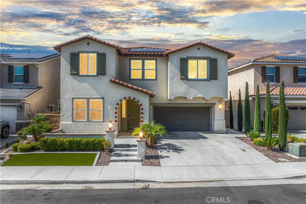 This home is nothing short of exquisite! Featuring 3,270 sq. ft., this two-story Sage floor plan is designed for spacious living with an effortless flow and elevated appeal. From the welcoming front porch to the thoughtfully crafted interior, every detail speaks of comfort and style. Step inside and you’ll be greeted by warm LVP flooring and a flood of natural light. Off the entry is a versatile office or den—ideal for remote work or a 5th bedroom. A stylish powder room on the first level adds convenience for guests. Continue down the hall and you’ll find the showstopping GREAT ROOM—a sprawling family space with surround sound that opens to the heart of the home: the kitchen. With extended cabinetry and counter space, white shaker style cabinets and drawers, a generous island, oversized walk-in pantry, range hood, upgraded black stainless-steel appliances, over island pendant lighting, and sparkling Quartz countertops, this kitchen brings style and function together beautifully. The spacious breakfast nook handles both casual meals and formal gatherings with ease. Head upstairs to discover so much more! The expansive primary suite is a private retreat with dual walk-in closets, ceiling fan, walk-in shower, deep soaking tub, and dual vanities. You'll love the marble style finishes with the porcelain tile on the tub an shower area tub. Just down the hallway, you’ll find three additional generously sized bedrooms and two full bathrooms. A large loft is a great space to have an additional area to relax and unwind. One of the bedrooms if right off the loft and is perfectly positioned near its own full bath—ideal for guests or teens. An upstairs laundry room equipped with a folding table and shelving makes daily tasks a breeze. Step outside to discover a clean and modern backyard—an inviting California room for dining and relaxing, plus a half-court basketball area perfect for fun and fitness. Drought-tolerant landscaping and water-saving turf offer beauty without the upkeep, while trees add privacy and shade. Additional highlights include plantation shutters, ceiling fans, LVP flooring, matte black hardware, plush carpet, fresh paint, solar panels, and much more. Located in the amenity-rich community of Spencer’s Crossing, you’ll enjoy access to resort-style pools (including a tot pool), spa, walking trails, and parks—all just minutes from Temecula Wine Country.
