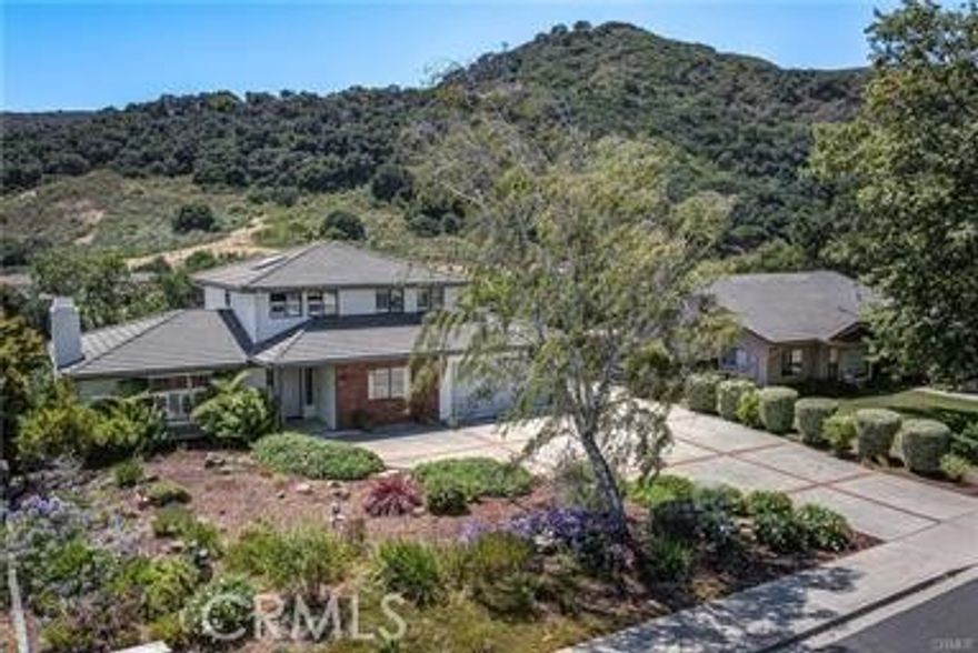 Perched on a peaceful cul-de-sac in San Luis Obispo’s coveted Irish Hills, this spacious 5-bedroom, 4-bath home offers the perfect blend of comfort, flexibility, and stunning natural beauty. The main residence boasts bright, open living spaces filled with natural light, a modernized kitchen ideal for gathering, and seamless indoor-outdoor flow to an expansive deck where panoramic mountain views set the scene for entertaining or quiet evenings at home. A rare highlight of this property is the fully permitted, 760 sq. ft. ADU with its own private entrance—perfect for extended family, visiting guests, or generating strong rental income. With multiple living areas, a cozy fireplace, and a versatile office/den, the home adapts easily to a variety of lifestyles. Situated on a generous lot surrounded by trails and open space, yet just minutes from downtown SLO, Cal Poly, and top-rated schools, this property captures the best of Central Coast living. Whether you’re seeking a multi-generational retreat or a smart investment, 967 Capistrano Court delivers both.